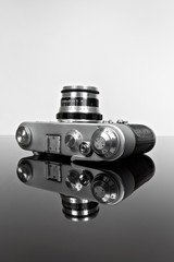 old camera on the glass with reflection