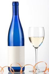 Blue bottle of white wine and wine glass