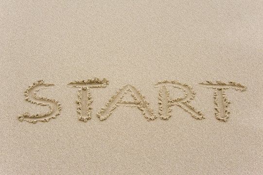 Start written in sandy beach