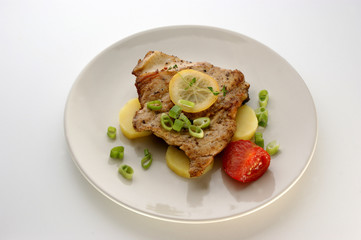 carp steak with potato and organic vegetable