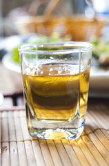 Glass with an alcoholic drink on the served table