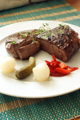 grilled rump steak with sour vegetable on a plate