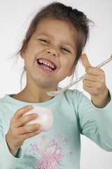 little successful girl eating yogurt