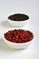 black and red pepper in a white bowl