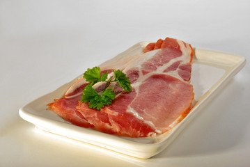 smoked bacon on a plate with organic parsley