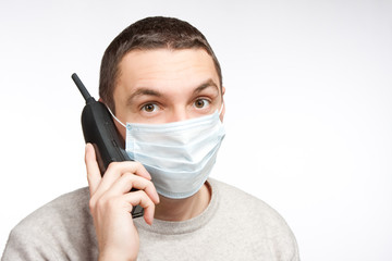 man talking by phone in protective mask