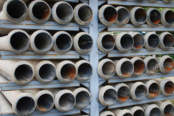 many stacked drain pipes on a construction site