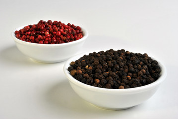 black and red pepper in a white bowl