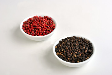 black and red pepper in a white bowl