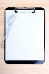 Blank clipboard and fork