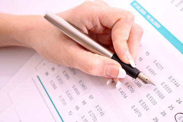 Pen in hand make some corrections in printed digits