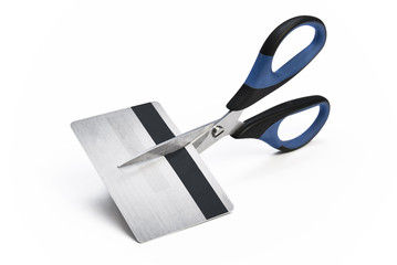 Scissors cutting credit card in halves