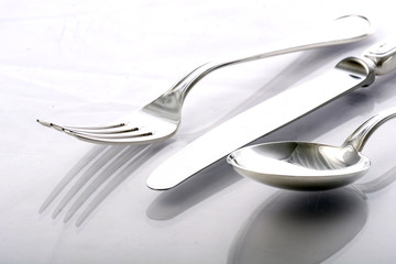 Flat lay of metallic cutlery spoon, fork, knife 