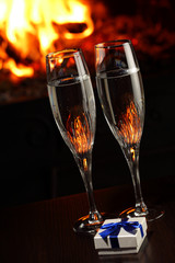 glasses with champagne, fire as the background