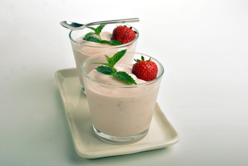 some organic strawberries in natural yogurt and mint