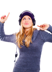 smiling blond woman with headphones listening music over white