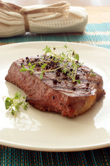 pepper steak with greek basil on a plate