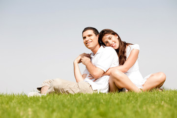 Happy young women with arms around her husband and laying