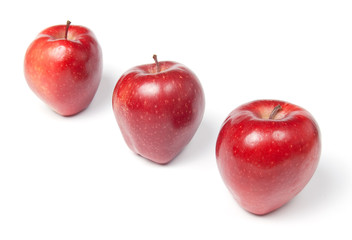 Three red apples in a row, isolated on white