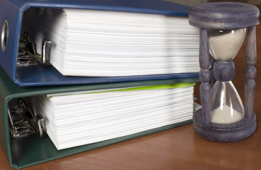 Block of documents with sand clock