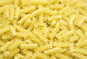 a background of Fusilli pasta from above