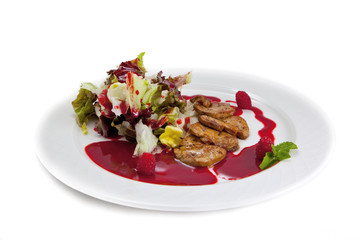Plate with Foie gras, salad leaves, a raspberry and a syrup