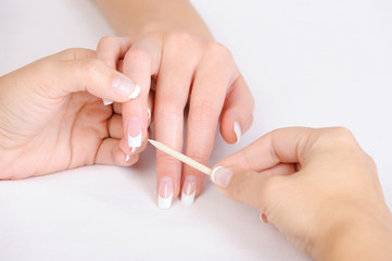 cleaning cuticle of  fingers with cosmetic stick
