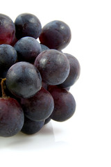 cluster of blue grapes over white background