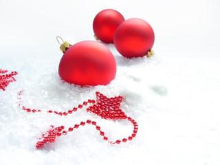 three red balls and stars in the snow