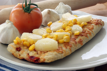 stone oven baked pizza with corn, tomato and garlic