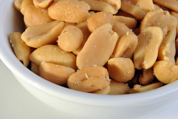 roasted salted peanuts in a white bowl