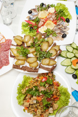 table with appetizers and black bread sandwiches with lard