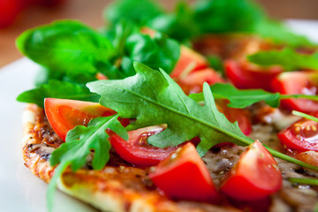 Pizza with cherry tomatoes and arugula