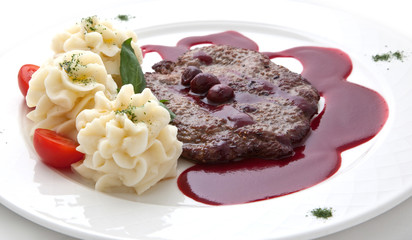 Veal under sweet sauce and a potato garnish