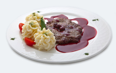 Veal under sweet sauce and a potato garnish