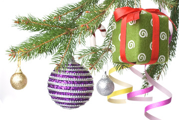 Christmas balls, gift and decoration on fir tree branch i
