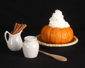 Pumpkin pie ingredients isolated on a black background