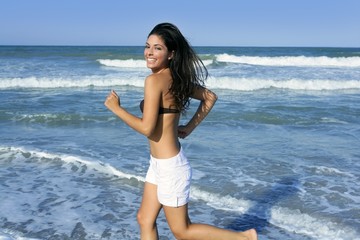 Fototapeta na wymiar Beautiful summer brunette girl jumping on the beach