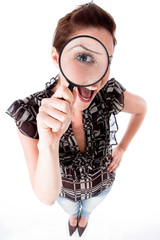 young woman looking up with a magnifying glass