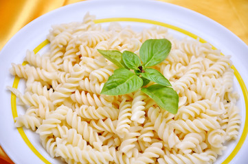 Italian macarony with original ingredients, on golden fabric