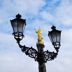 Fototapeta na wymiar berlin victory column siegessaeule and a historic street light