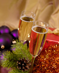 Christmas still-life with champaigne on golden background