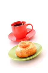 Buns and cup of tea on white