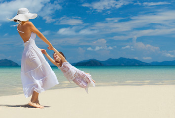 woman and girl on the beach