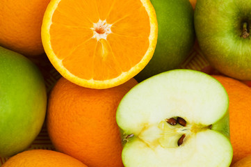 Close up of half cut oranges and apples