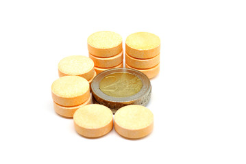 C vitamin pills and euro coins