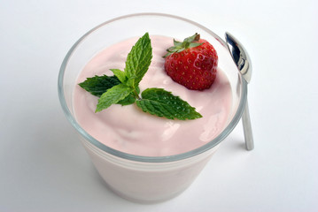 one organic strawberry in yogurt and mint