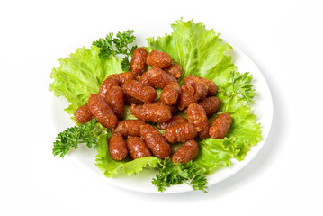 grilled sausages on green lettuce