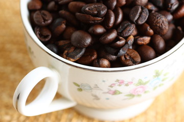 cup filled with freshly roasted coffee beans