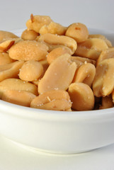 roasted salted peanuts in a white bowl